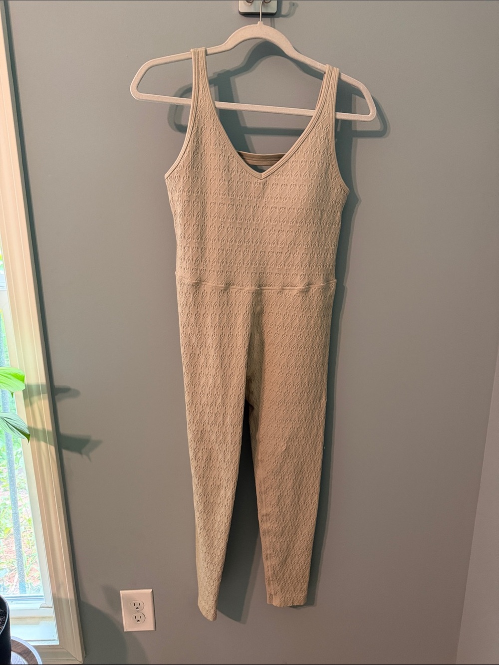 Tan one piece built in shelf bra with pads. NWOT, never worn. Chest/waist 15”